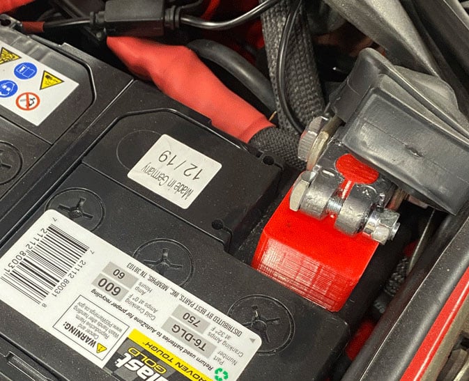 Battery cable isolator used to keep the disconnected cable away from the battery post